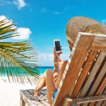 Young woman with tablet pc at the beach