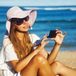 young woman with mobile phone on a beach, bali