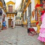 Shopping street with typical flamenco dress in Seville, Spain.
